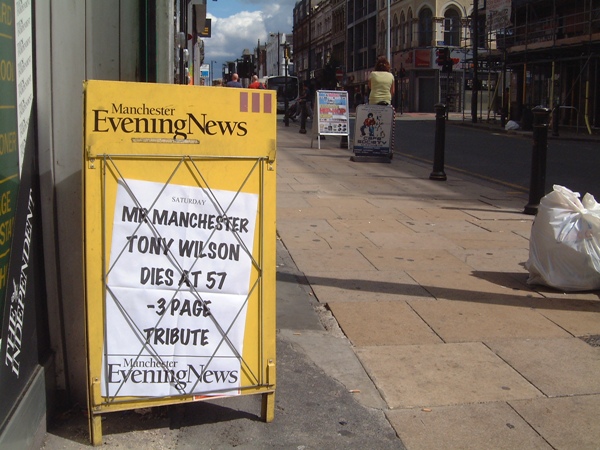 Manchester Evening News street hoarding announcing the death of Tony Wilson, set against the background of Oldham Street and Dry